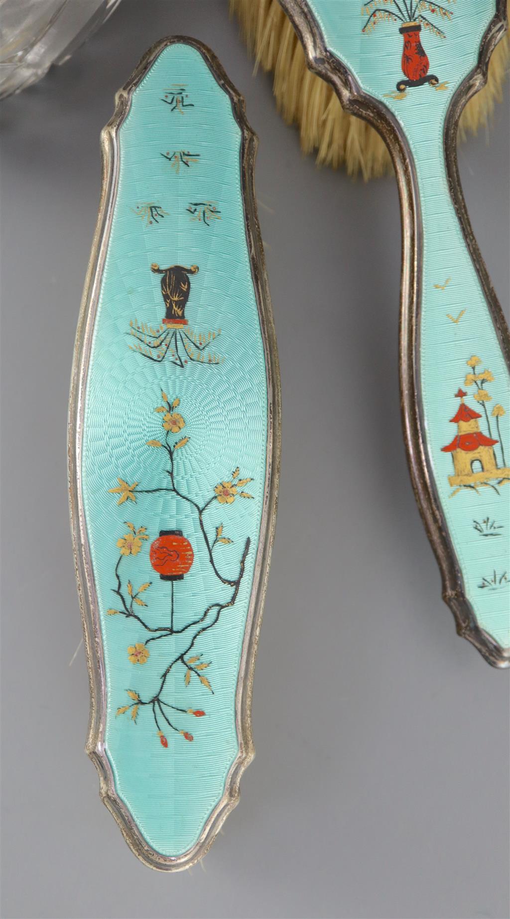 A 1920s silver and gilded chinoiserie guilloche enamel eight piece dressing table set, by Adie Bros,